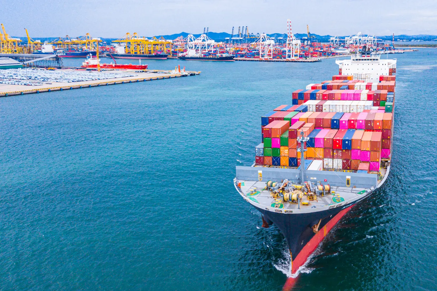 Cargo ship loaded with colorful shipping containers, representing bulk trade, wholesale distribution, and reseller opportunities.